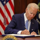 U.S. President Joe Biden signs the Bipartisan Safer Communities Act into law in the Roosevelt Room of the White House on June 25, 2022 in Washington, DC.